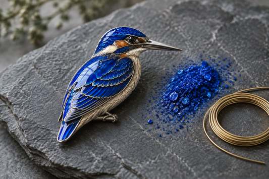 Sterling silver kingfisher brooch with cobalt blue fired enamel on slate, beside blue enamel powder and cloisonné wire