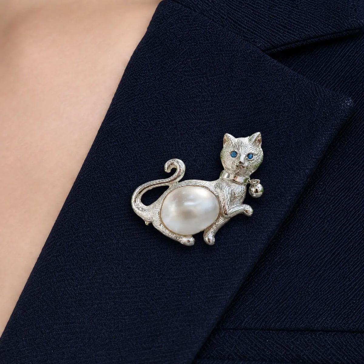 Artisan sterling silver paw-raised cat brooch styling detail with freshwater pearl belly