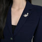 Handmade paw-raised cat silver brooch worn on clothing — convertible pendant styling photo