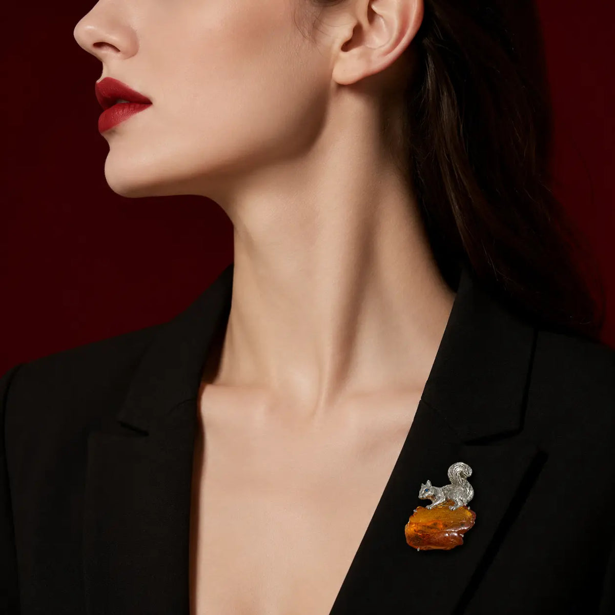 Artisan sterling silver curled-tail squirrel brooch styling detail with natural amber