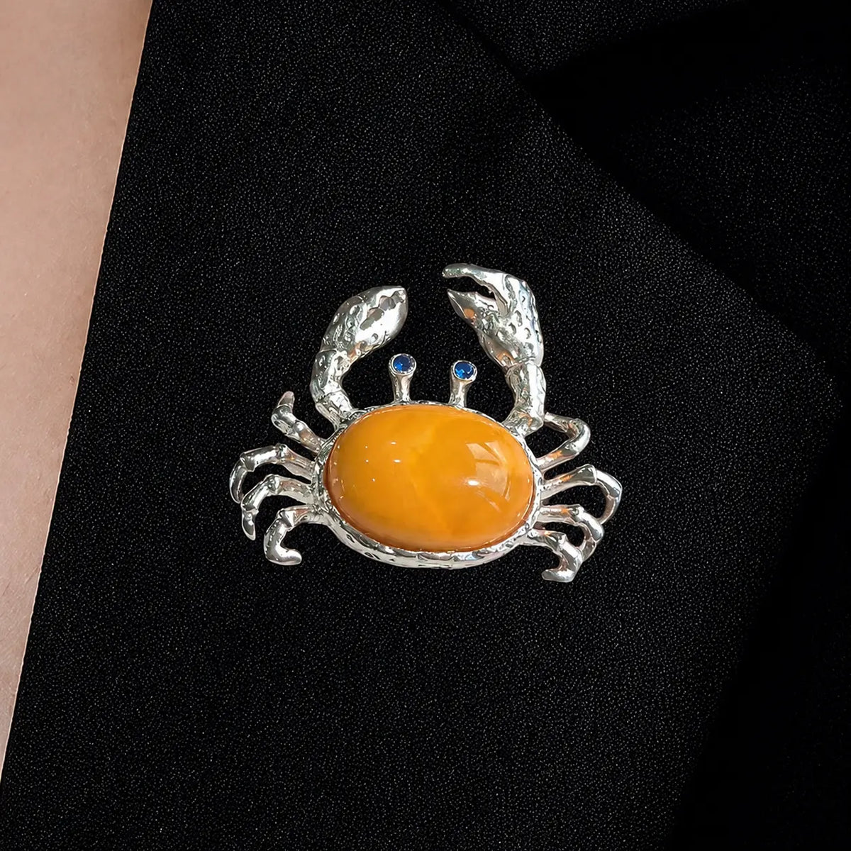 Handmade raised-claw crab silver brooch worn on clothing — convertible pendant styling photo
