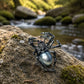 luminous gray pearl creeping spider silver brooch in a nature-inspired styling photo