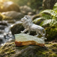 Handmade silver majestic lion brooch styled in a natural scene — artisan jewelry photo