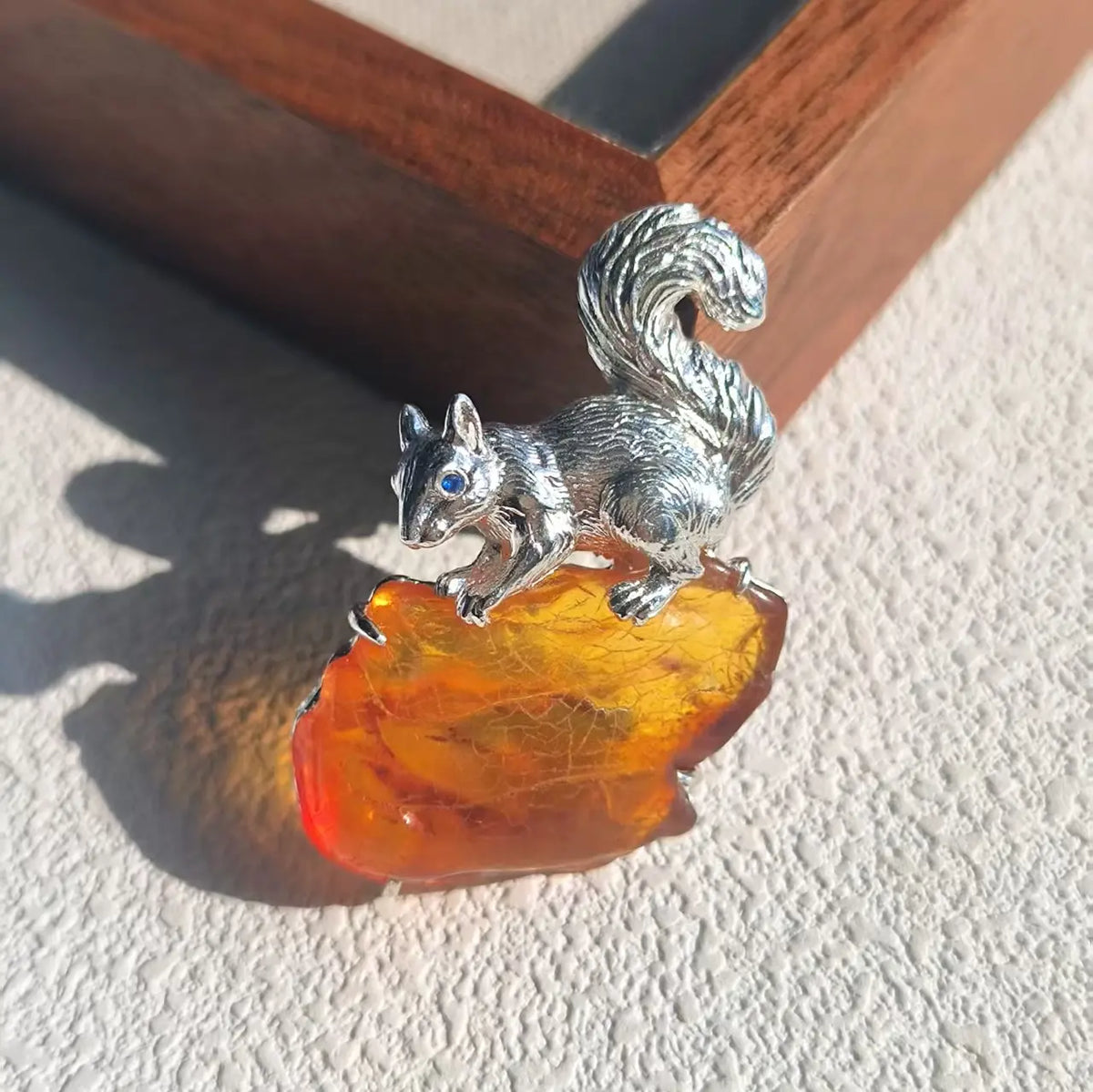 Artisan silver curled-tail squirrel brooch — handmade jewelry product image