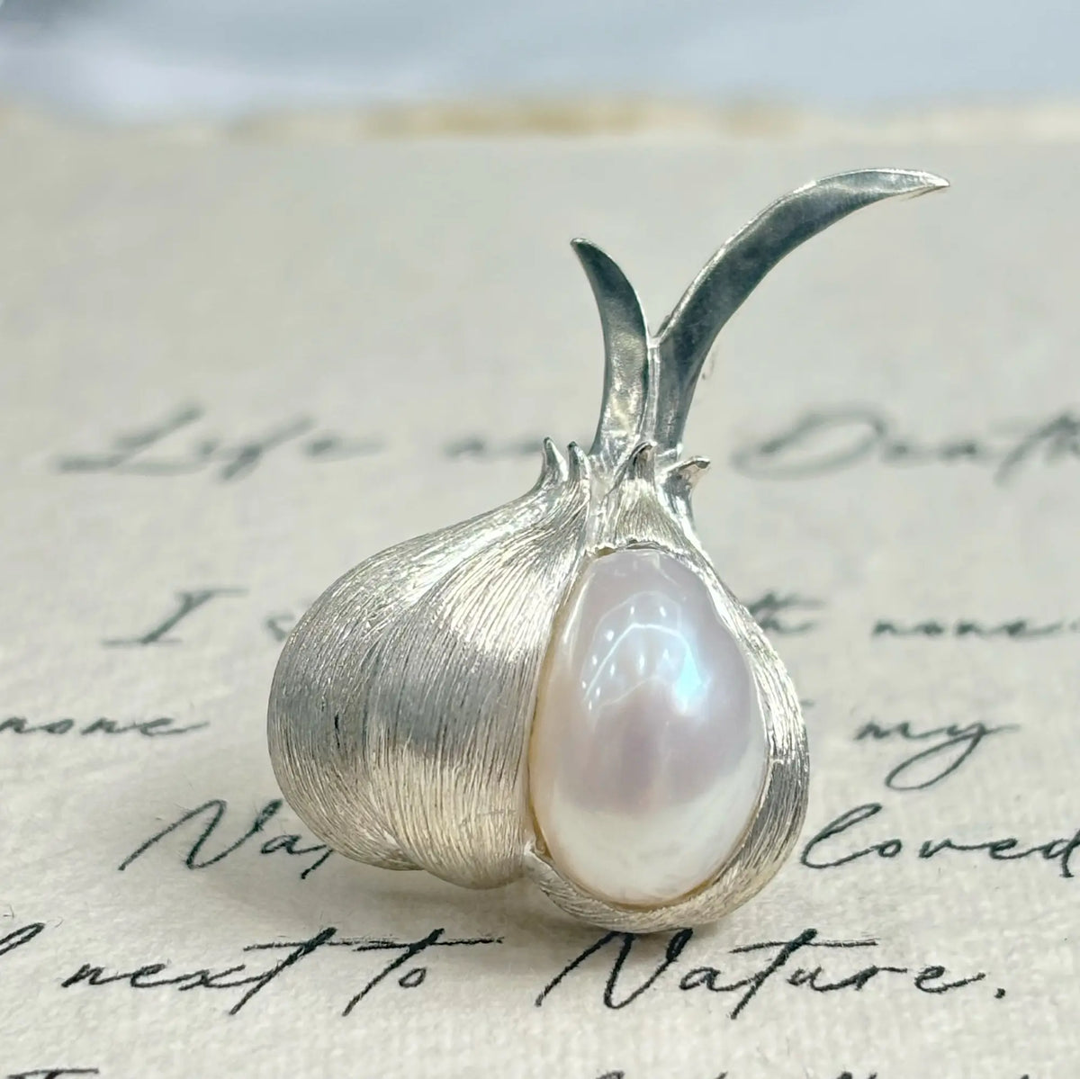 Artisan silver peeled garlic brooch — handmade jewelry product image