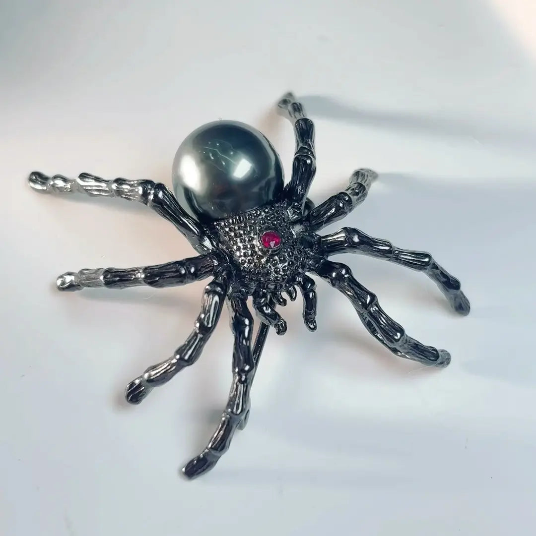 Artisan silver web-spinning spider brooch — handmade jewelry product image