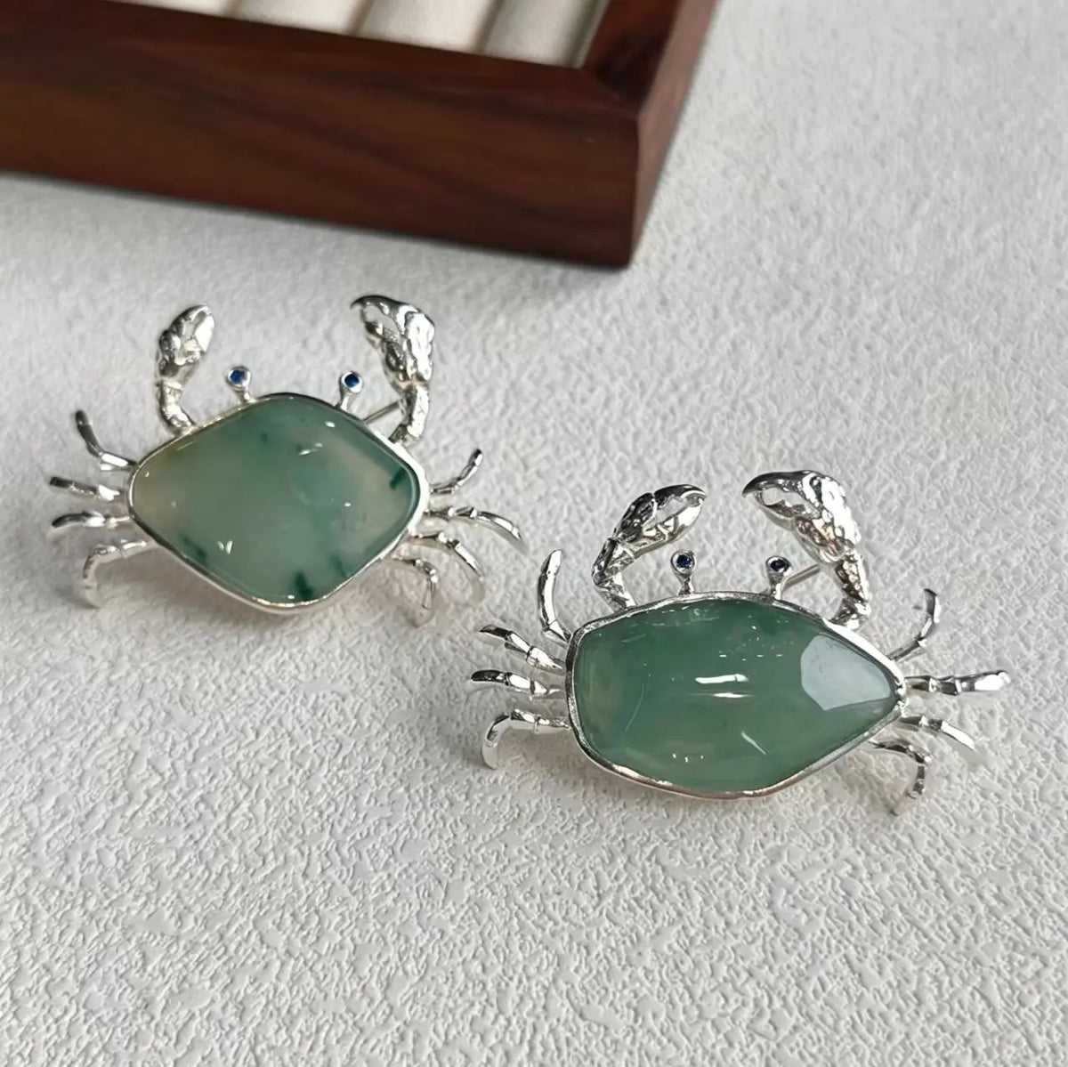 natural jadeite spread-claw crab silver brooch detail — jewelry close-up photo