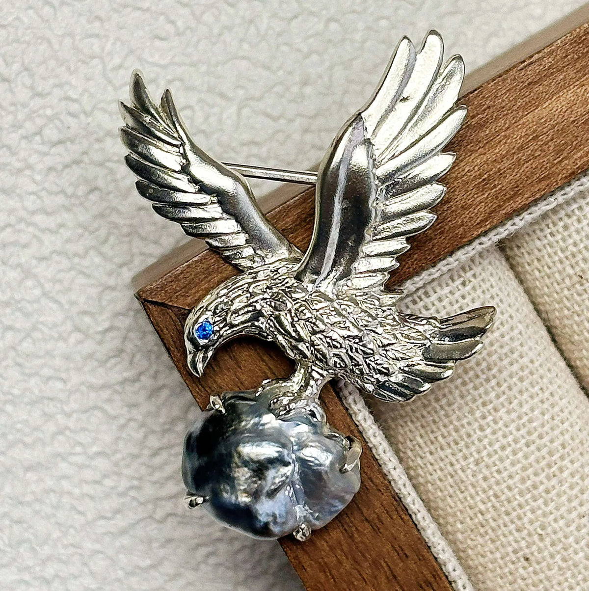 Artisan sterling silver perched eagle brooch styling detail with baroque saltwater pearl