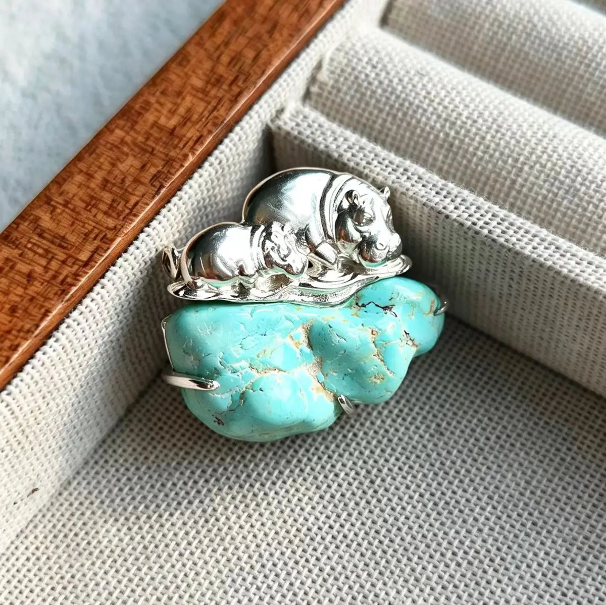 Convertible mother & calf hippo silver pendant and brooch in a styling photo
