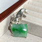Sterling silver regal leopard brooch pinned to textile — handmade jewelry detail