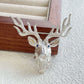 Sterling silver majestic stag brooch pinned to textile — handmade jewelry detail