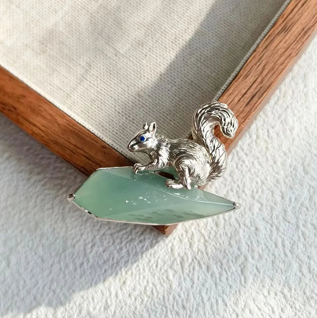 Artisan sterling silver gathering squirrel brooch styling detail with natural green jadeite