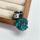 Sterling silver serene panda brooch pinned to textile — handmade jewelry detail