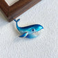 Artisan sterling silver gliding whale brooch styling detail with gradient blue enamel