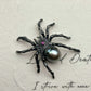 black pearl web-spinning spider silver brooch detail — jewelry close-up photo