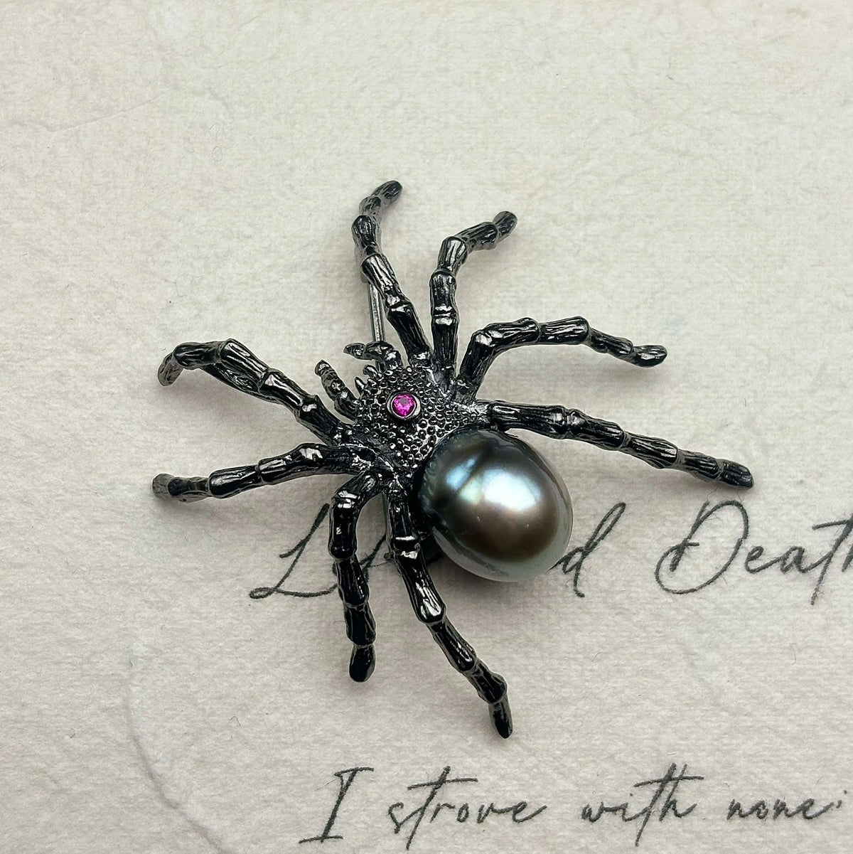black pearl web-spinning spider silver brooch detail — jewelry close-up photo