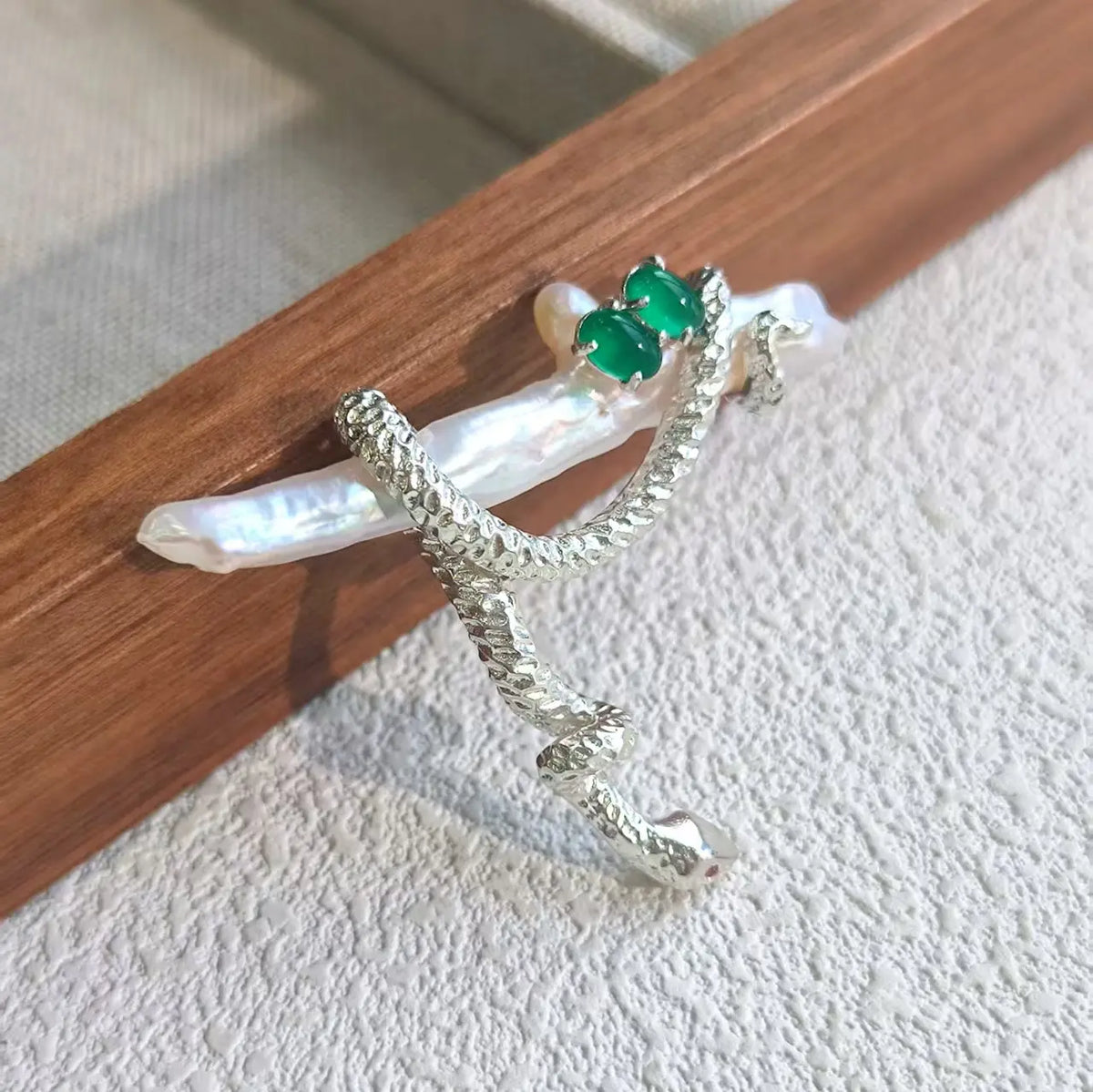 Artisan sterling silver coiling snake brooch styling detail with baroque pearl