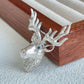 Convertible majestic stag silver pendant and brooch in a styling photo