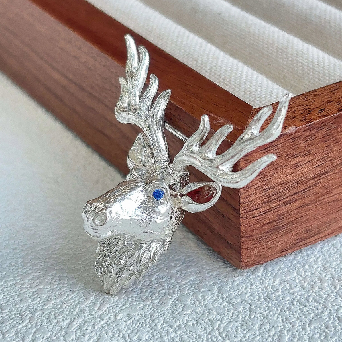 Convertible majestic stag silver pendant and brooch in a styling photo