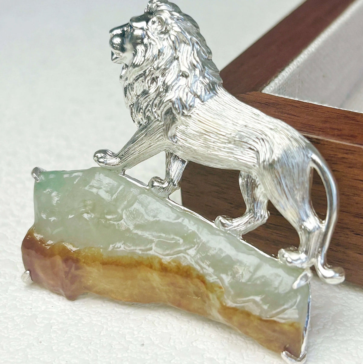 natural jadeite majestic lion silver brooch detail — jewelry close-up photo
