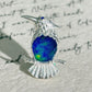 cobalt blue enamel perched kingfisher silver brooch detail — jewelry close-up photo