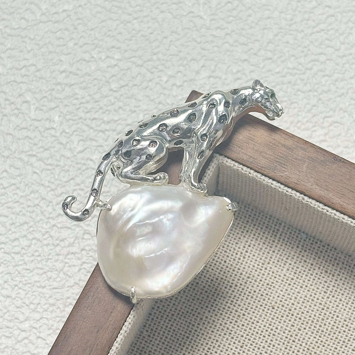 Artisan sterling silver crouching leopard brooch styling detail with baroque pearl