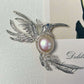 Artisan silver fluttering hummingbird brooch — handmade jewelry product image