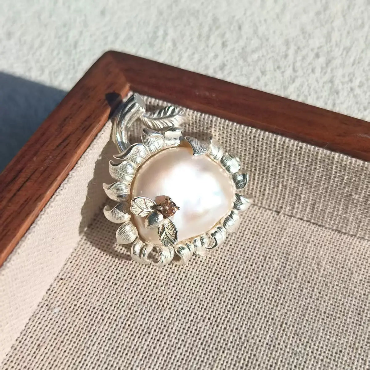 Convertible radiant sunflower silver pendant and brooch in a styling photo