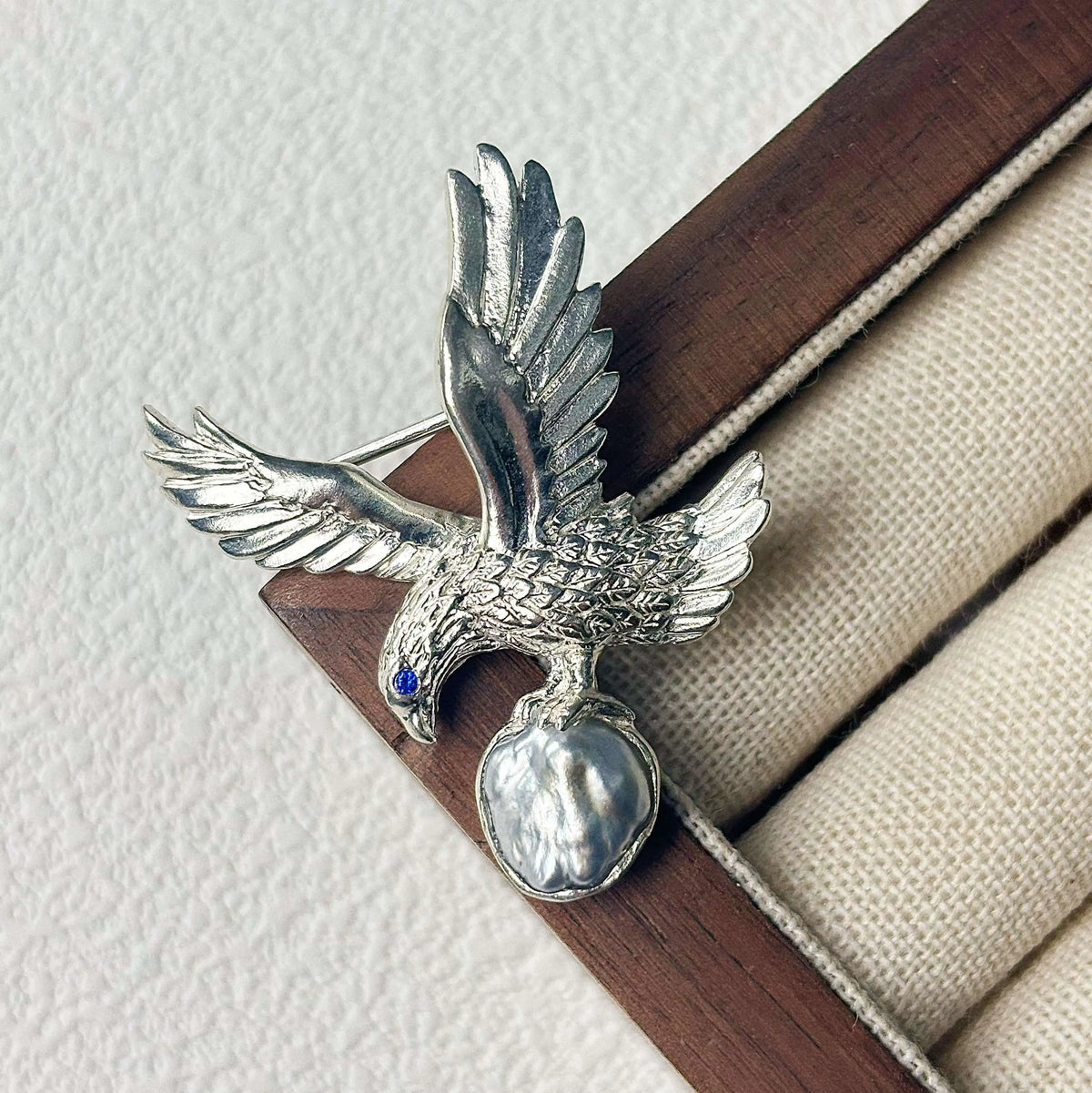2-in-1 perched eagle silver brooch and pendant styled on fabric