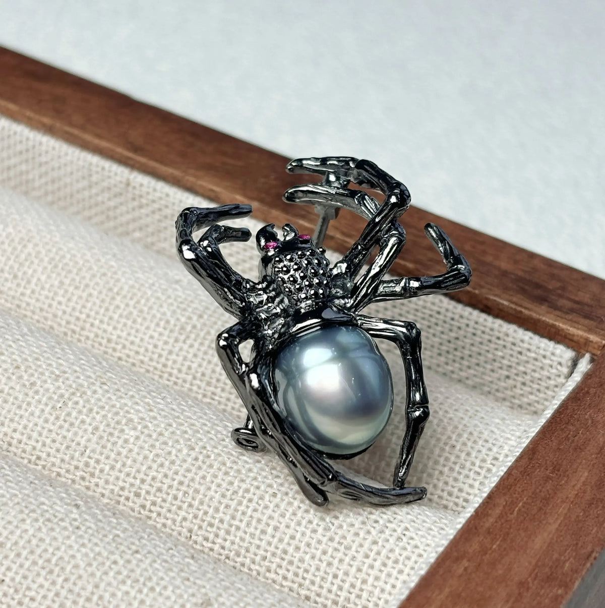 Artisan sterling silver creeping spider brooch styling detail with luminous gray pearl