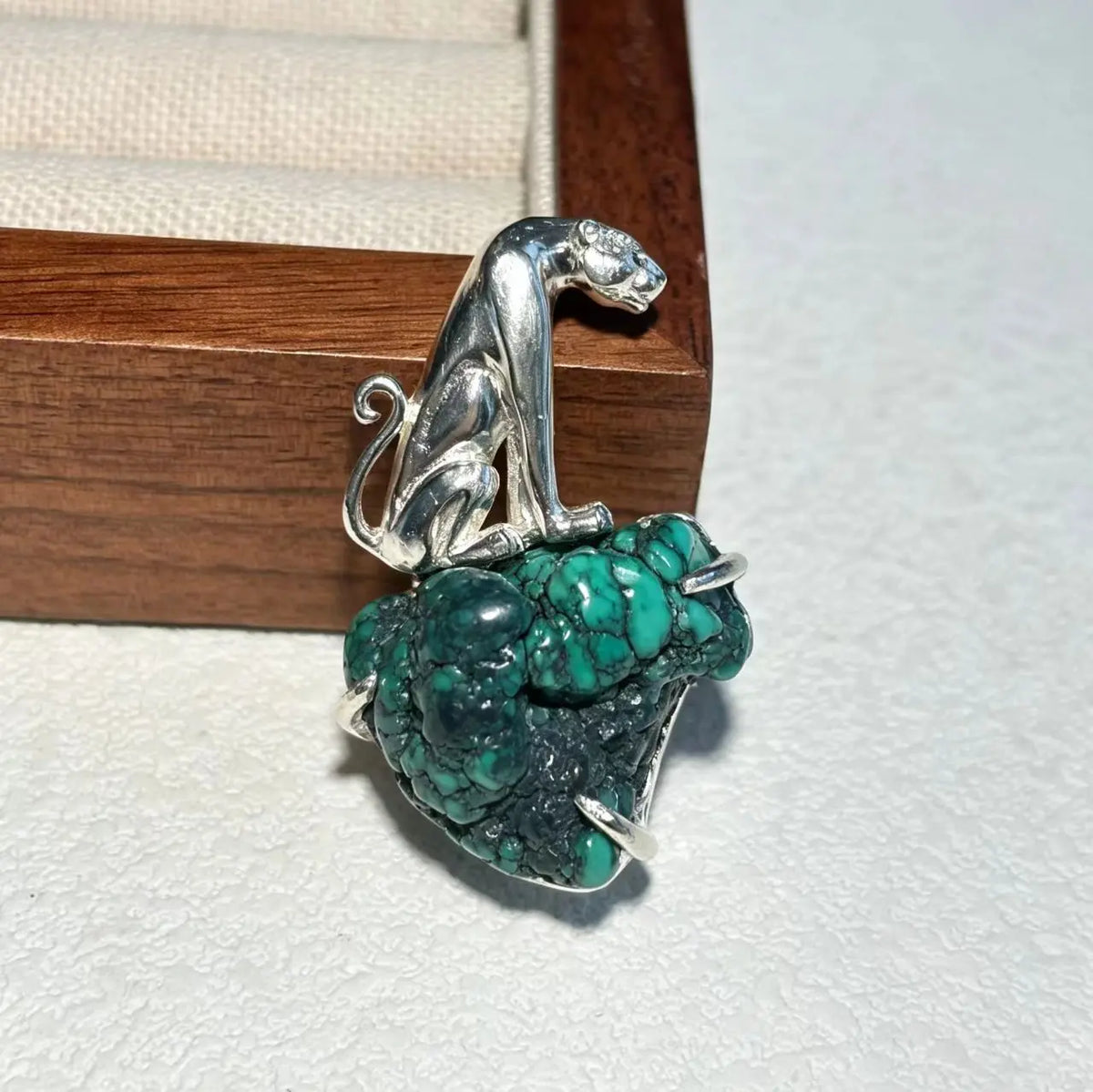 Handmade natural turquoise seated leopard brooch for women — wearable silver jewelry detail