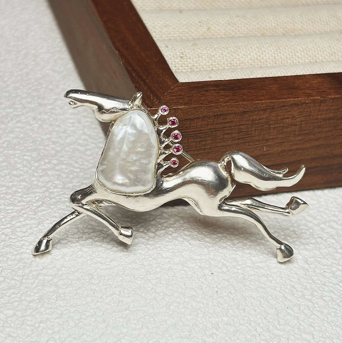 Artisan sterling silver galloping horse brooch styling detail with baroque pearl